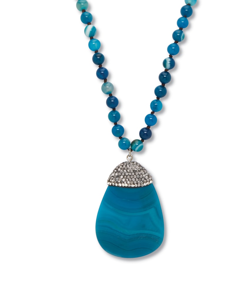Front of a size 34 in Round Genuine Blue Agate Crystal Accented Silvertone Drop Necklace 34 Inch in Blue by PalmBeach Jewelry. | dia_product_style_image_id:333317